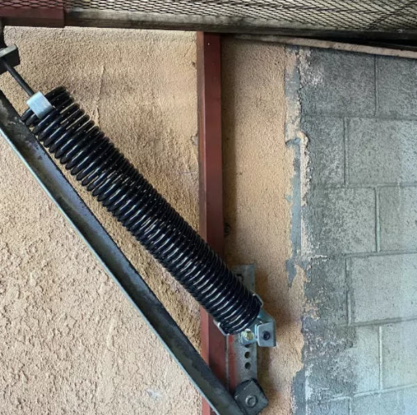 Professional technician performing garage door spring repair at Johnstown Ohio Garage Door Repair, highlighting expert maintenance services