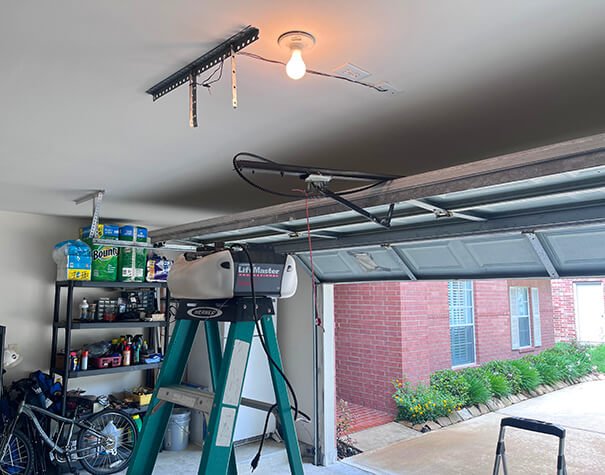 Professional technician performing garage door opener installation in Johnstown, Ohio