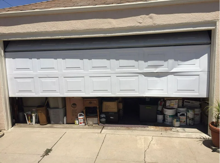 Professional technician performing garage door section replacement with precision tools in Johnstown, Ohio.