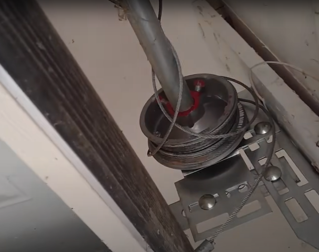 Close-up of a garage door cable being repaired by a professional technician in Johnstown, Ohio.