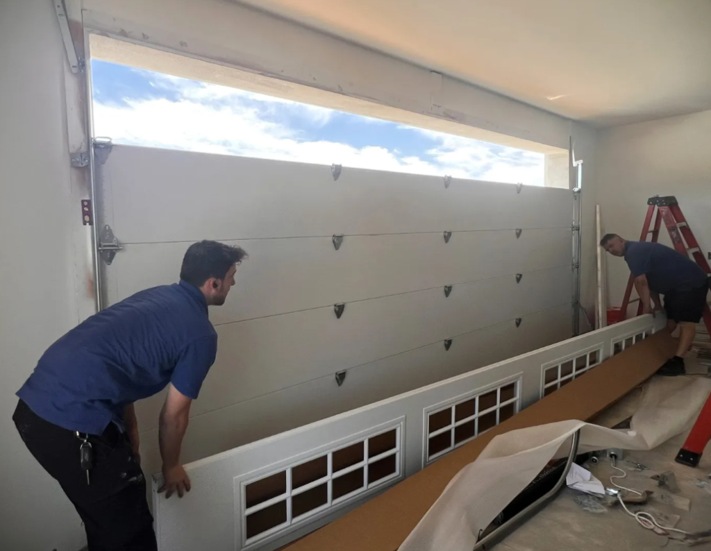 Professionals doing garage door with section replacement, showcasing improved functionality and aesthetics - Johnstown Ohio Garage Door Repair.