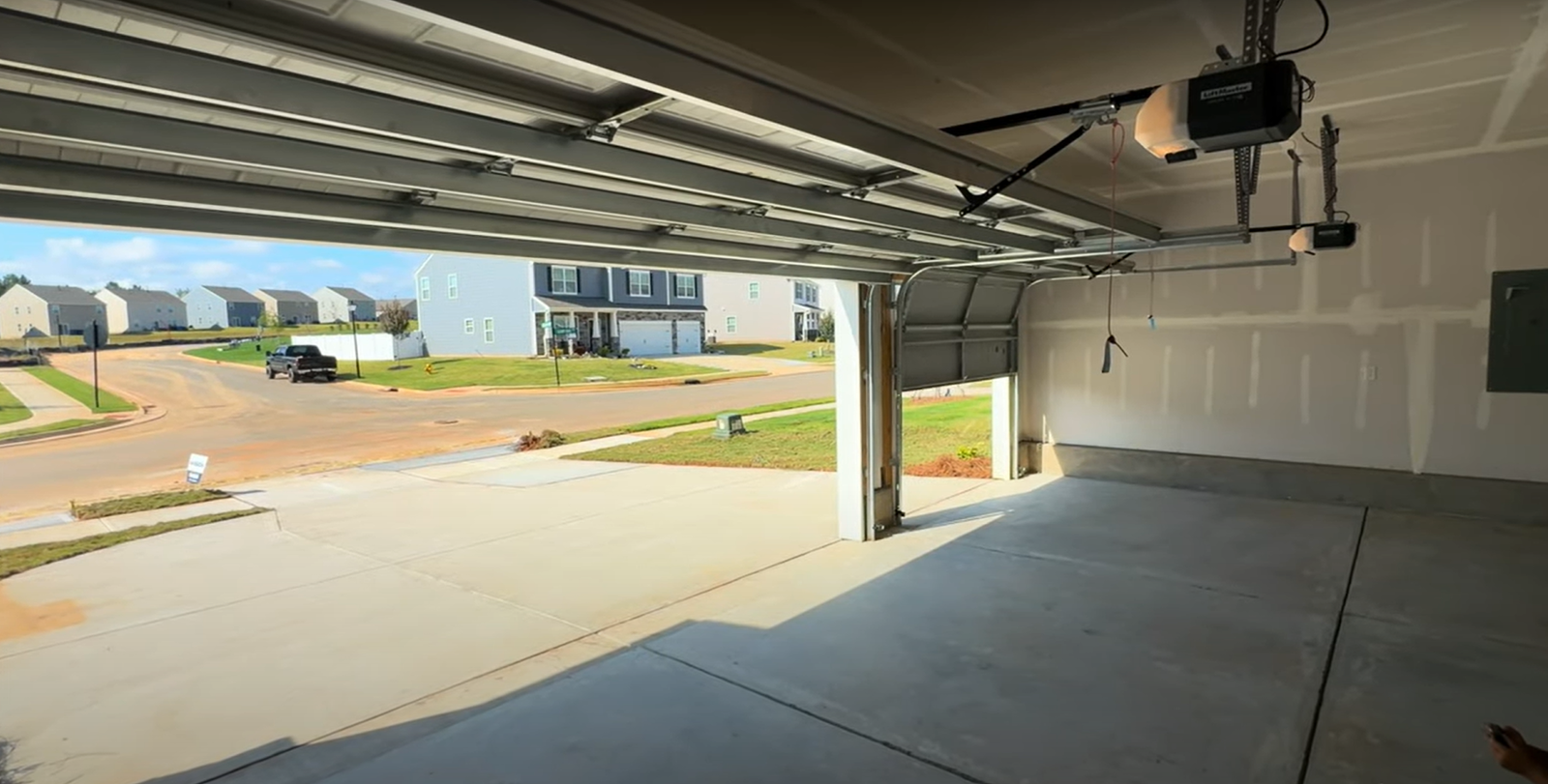 Before-and-after comparison of a garage door depicting the transformation from an old, damaged door to a new, replacement door by Johnstown Ohio Garage Door Repair, featuring garage door replacement.