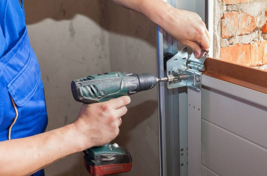 Professional technician fixing a noisy garage door in Johnstown, Ohio - Johnstown Ohio Garage Door Repair service for quiet operation