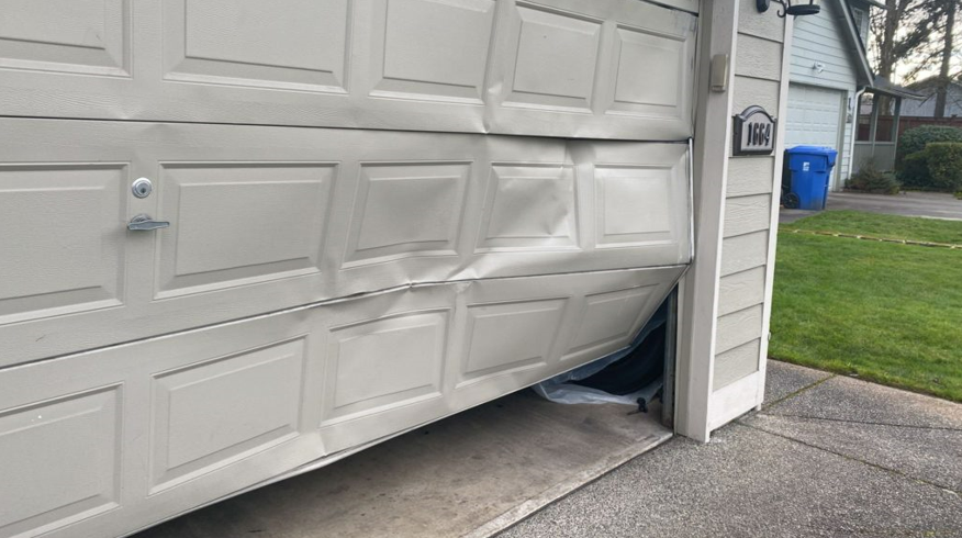 Professional technician performing garage door panel repair in Johnstown, Ohio, showcasing expert service.