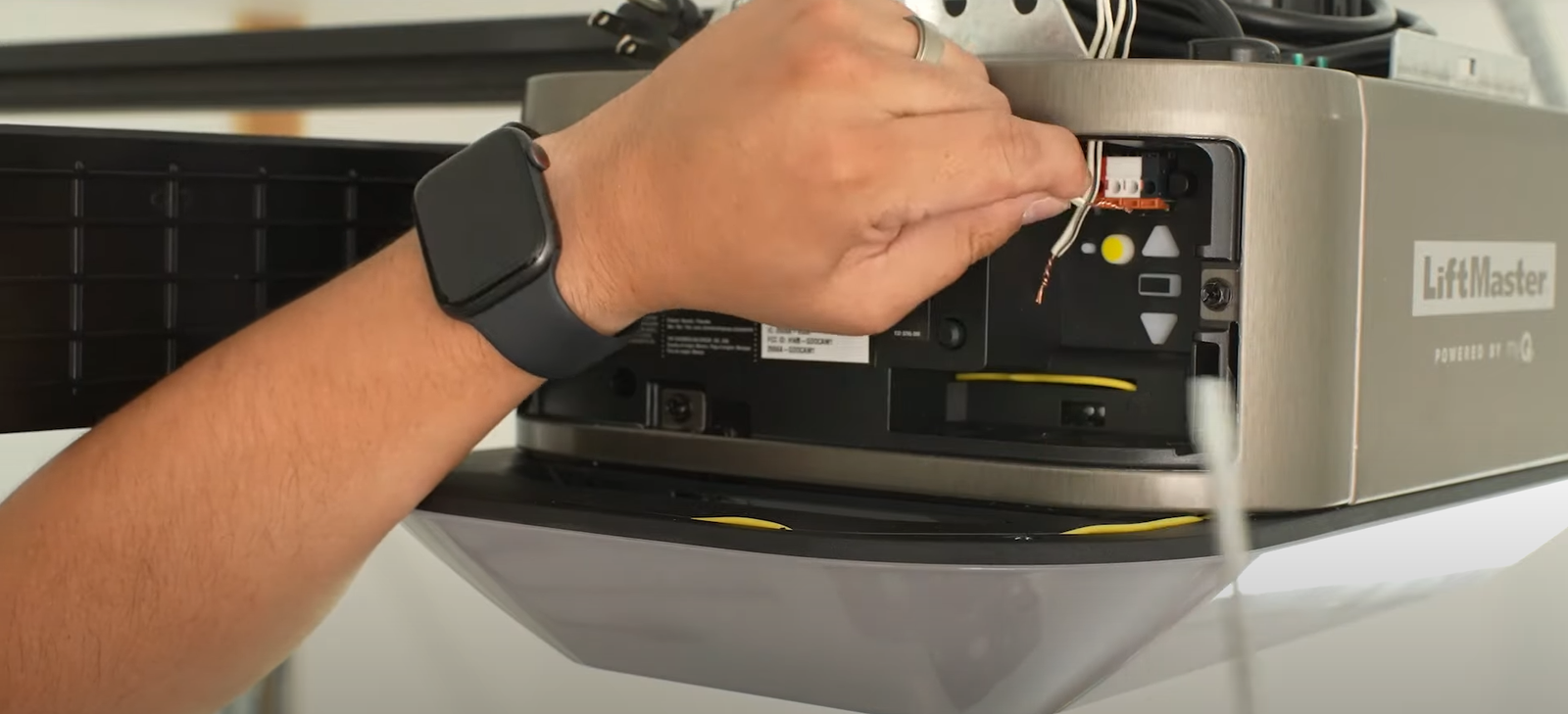 Close-up of a technician repairing a garage door opener in Johnstown, Ohio, highlighting expert garage door opener repair services