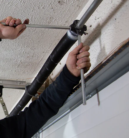 Close-up image of a broken garage door spring in Johnstown, Ohio, highlighting the need for expert repair services from Johnstown Ohio Garage Door Repair LLC.
